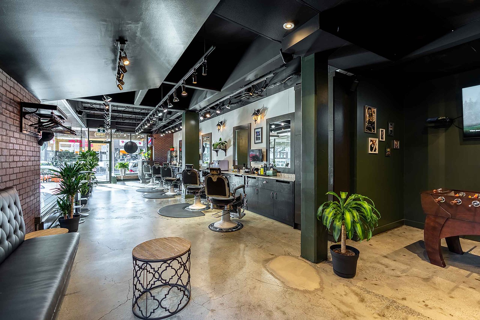 Interior of El Baron barbershop in Kitsilano, Vancouver, with stylish decor and multiple barber chairs.