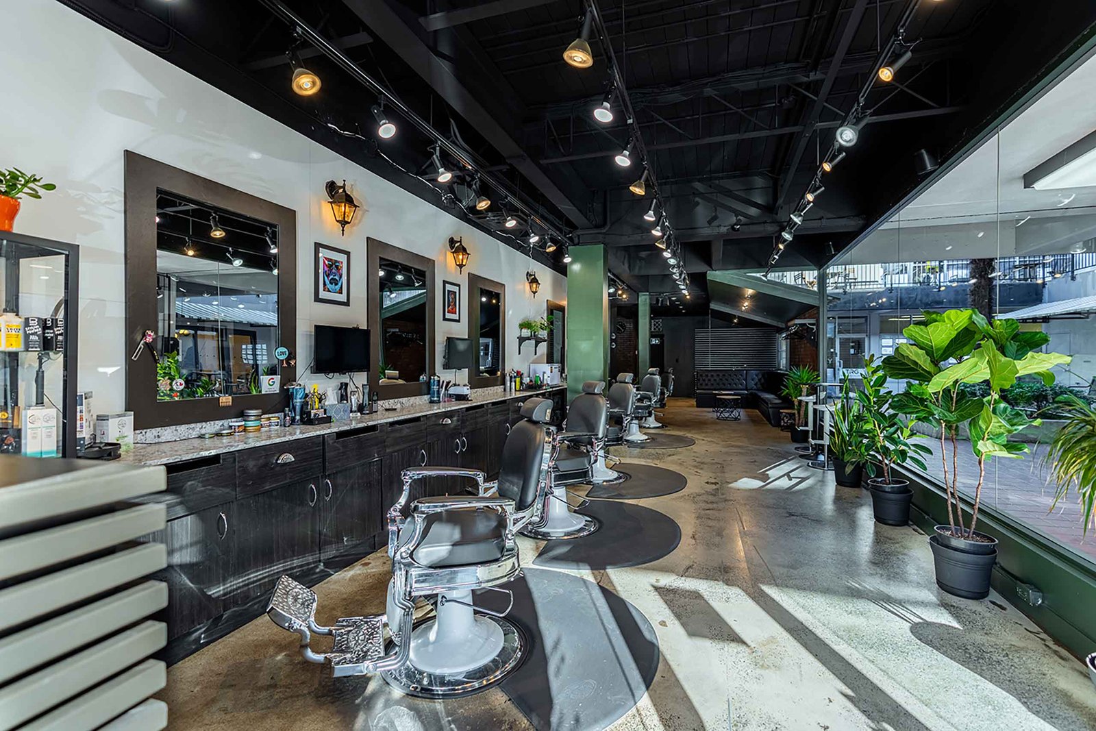 Interior of El Baron barbershop in Kitsilano, Vancouver, with stylish decor and multiple barber chairs.