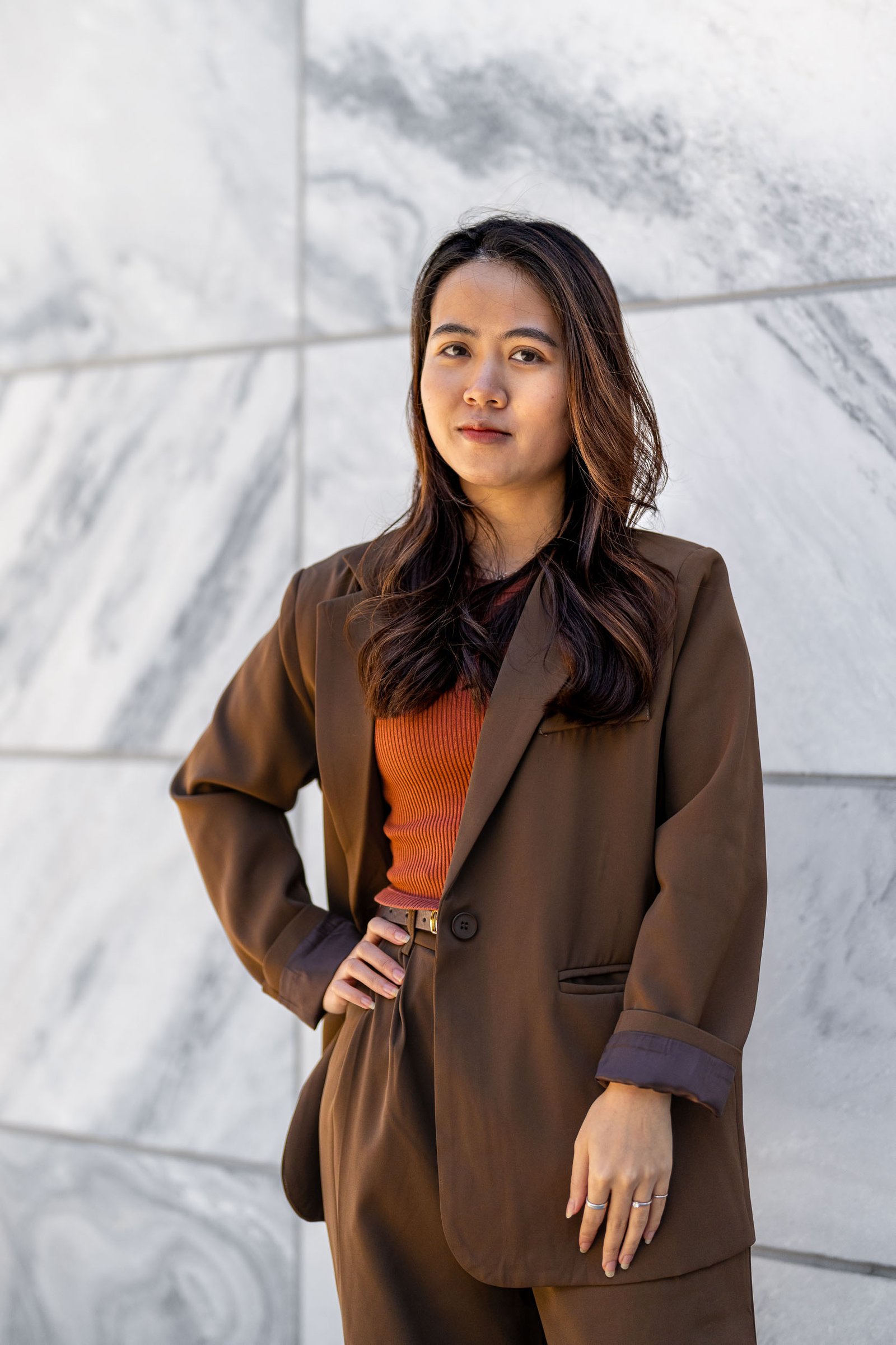 a woman in a brown suit